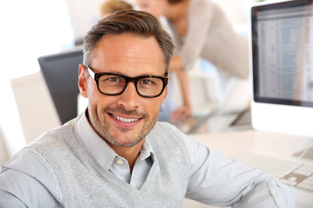 Man with glasses at an office job